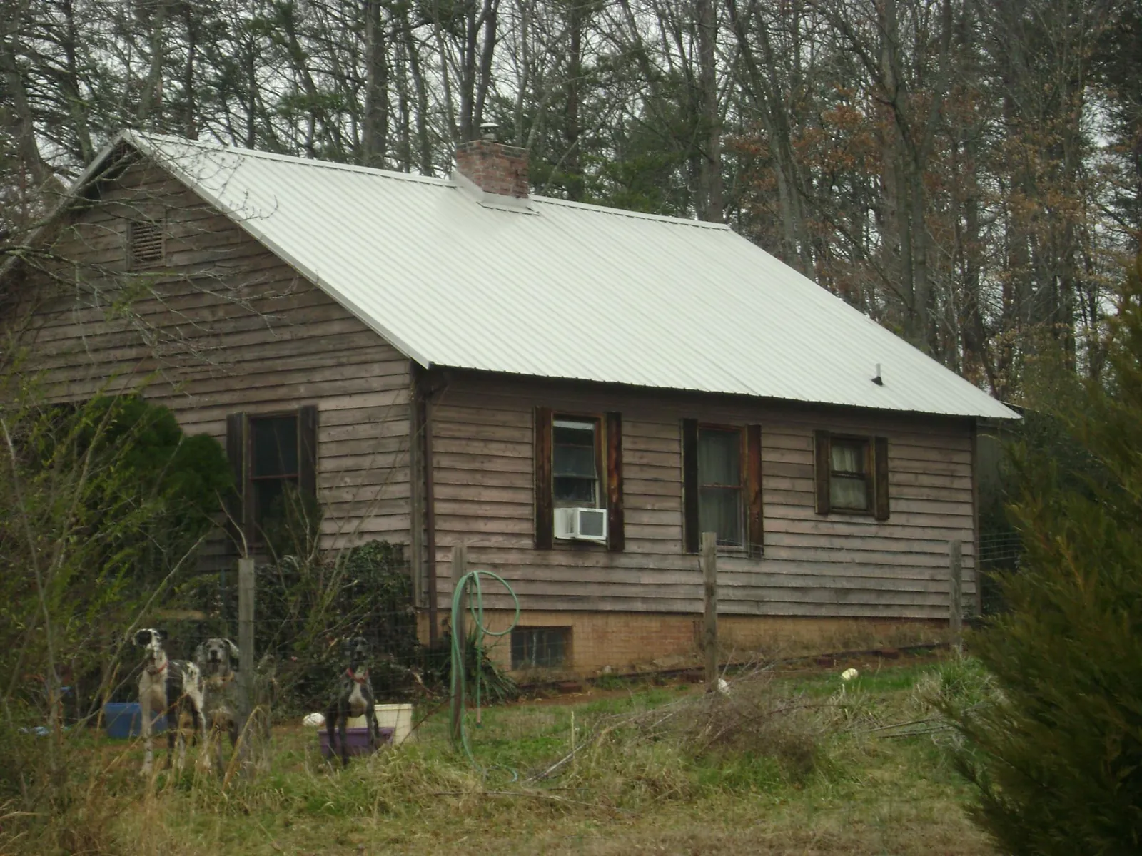 White metal roof on an old wood sided farmhouse, from a Metal Roof Installation job in Chesterton